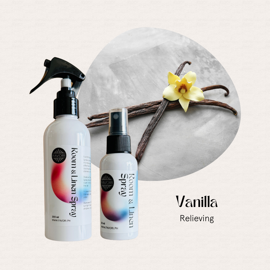 A FAVORI Scents Regular Room & Linen Air Spray bottle beside fragrant vanilla sticks.