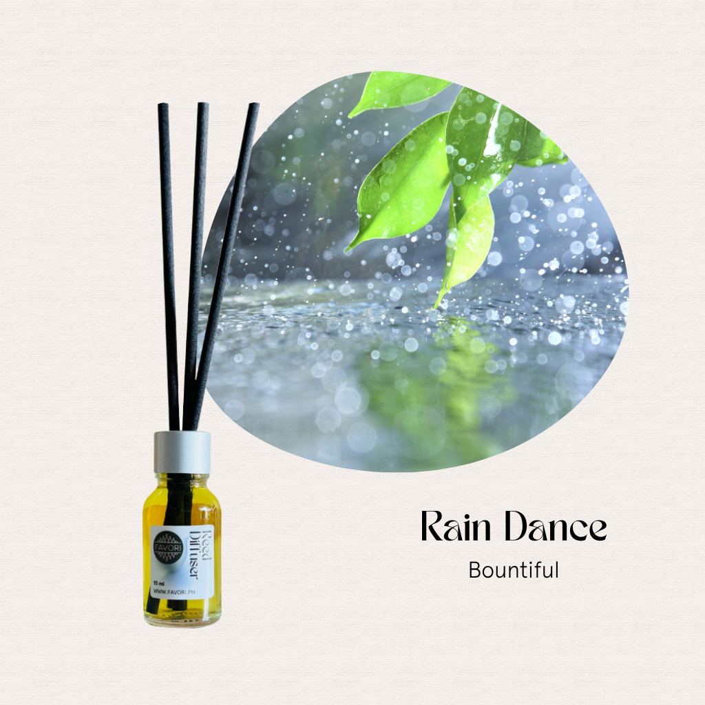 A FAVORI Scents Mini Reed Diffuser with anti-microbial sticks sits beside green leaves in the rain.