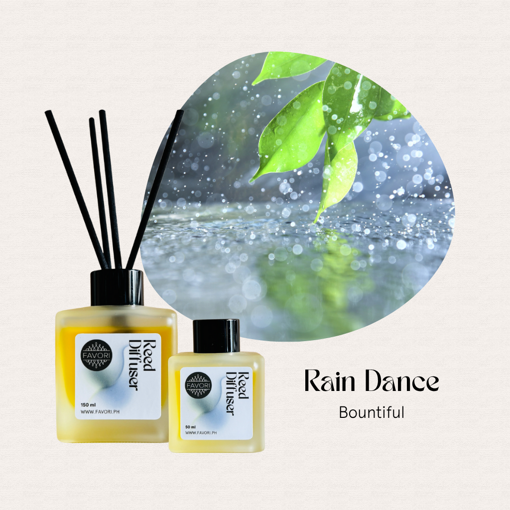 Two FAVORI Scents Rain Dance Regular Reed Diffusers with green leaves and raindrops on a light background.