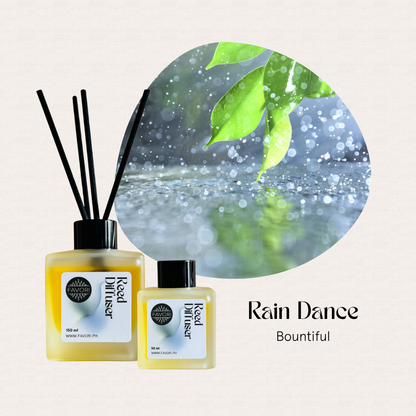 Two FAVORI Scents Rain Dance Regular Reed Diffusers with green leaves and raindrops on a light background.