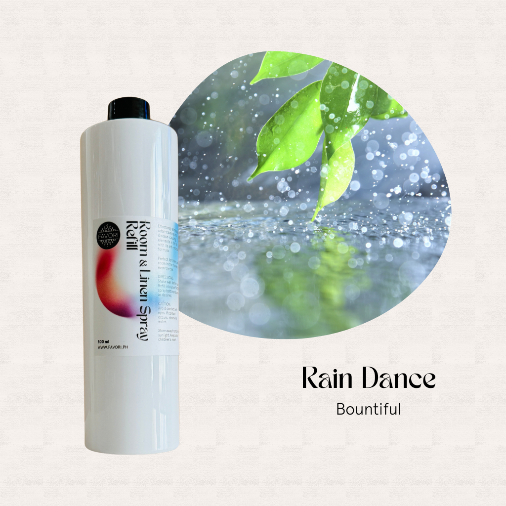 A FAVORI Scents 500ml Refill Room & Linen Air Spray, labeled Rain Dance Bountiful, with green leaves in rain.