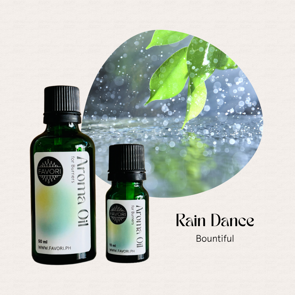 Two Burner Aroma Oils by FAVORI Scents with leafy logo, set against rain-dappled and green leaf background.