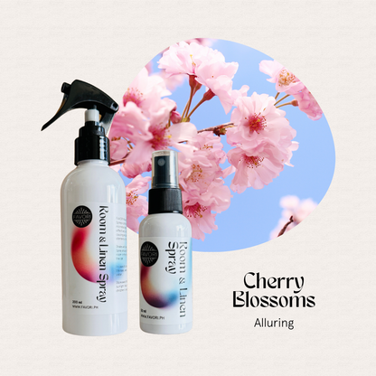 Two FAVORI Scents Regular Room & Linen Air Sprays with cherry blossoms and blue sky in the background.