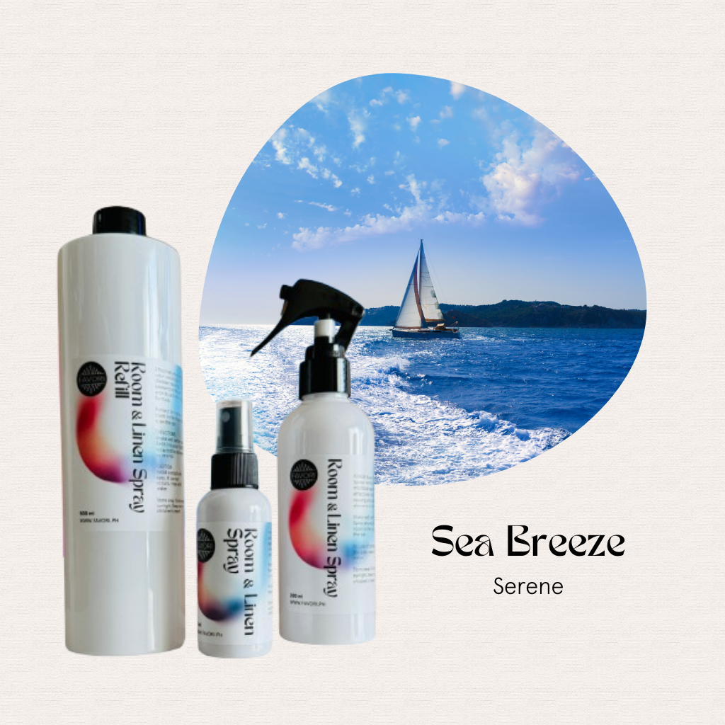 Three FAVORI Scents Trio Room & Linen Air Sprays sit beside a sailboat on bright blue ocean water.