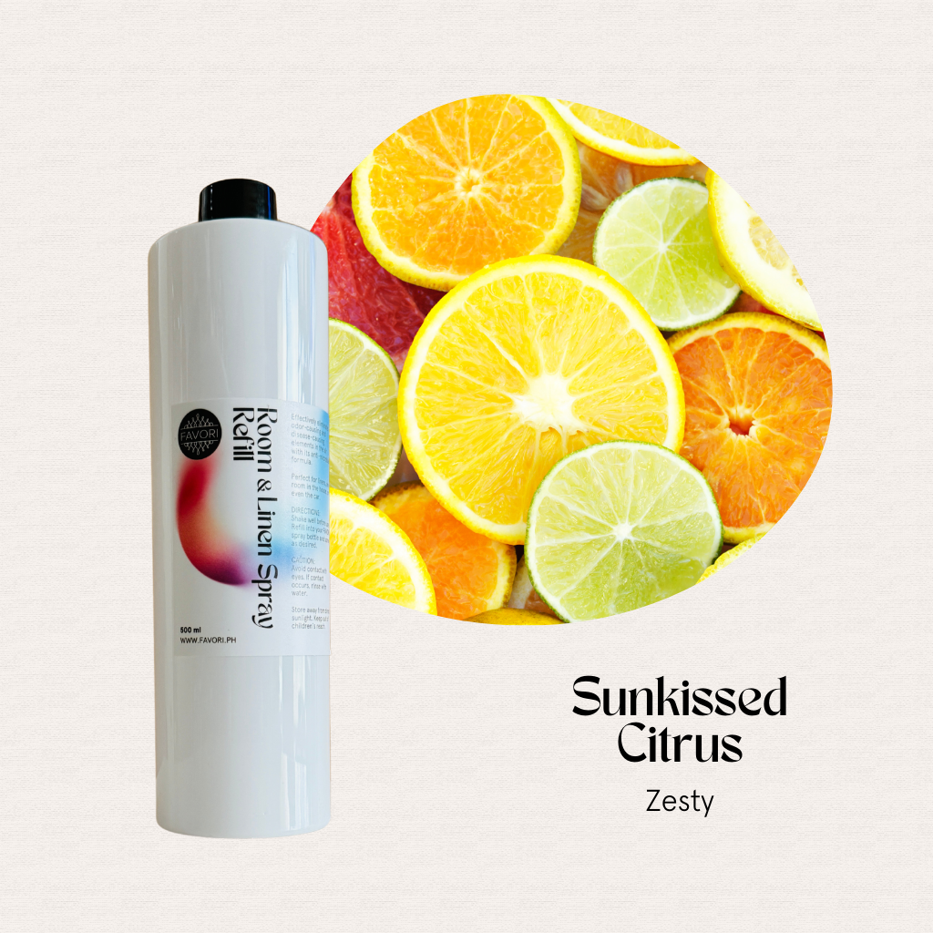 A FAVORI Scents Refill – Regular Room & Linen Air Spray 500ml beside sliced citrus fruits.