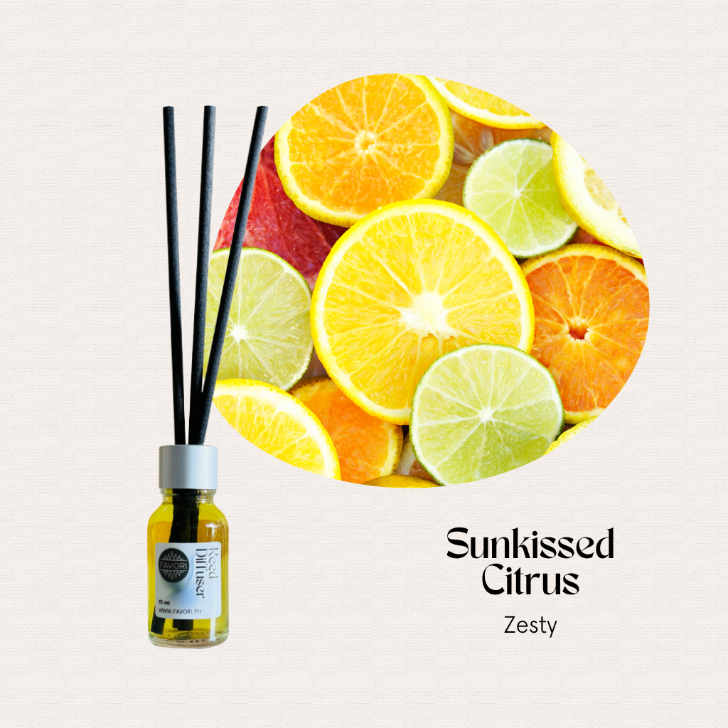 A FAVORI Scents Mini Reed Diffuser (MRD) in Sunkissed Citrus sits beside sliced citrus on a light background.