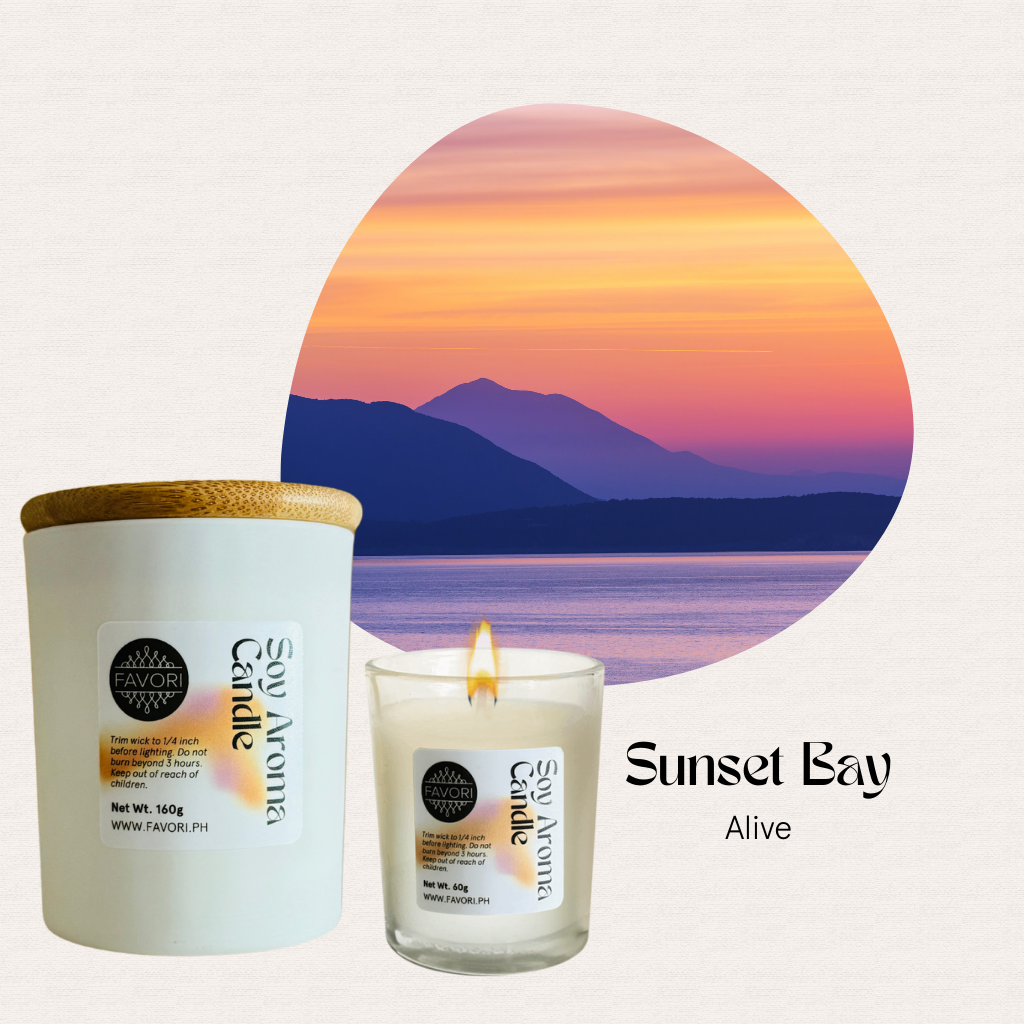FAVORI Scents All Occasion soy candles in white jars set beside a colorful sunset bay with mountains.