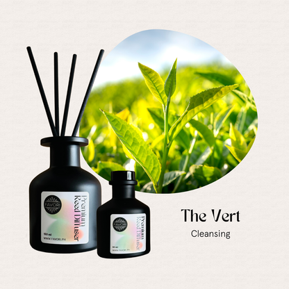 Two FAVORI Scents The Vert Premium Reed Diffusers with fresh green tea leaves in sunlight.
