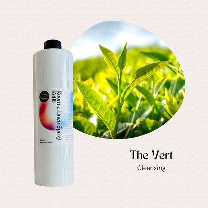 A white FAVORI Scents Refill – Regular Room & Linen Air Spray 500ml beside bright green tea leaves.