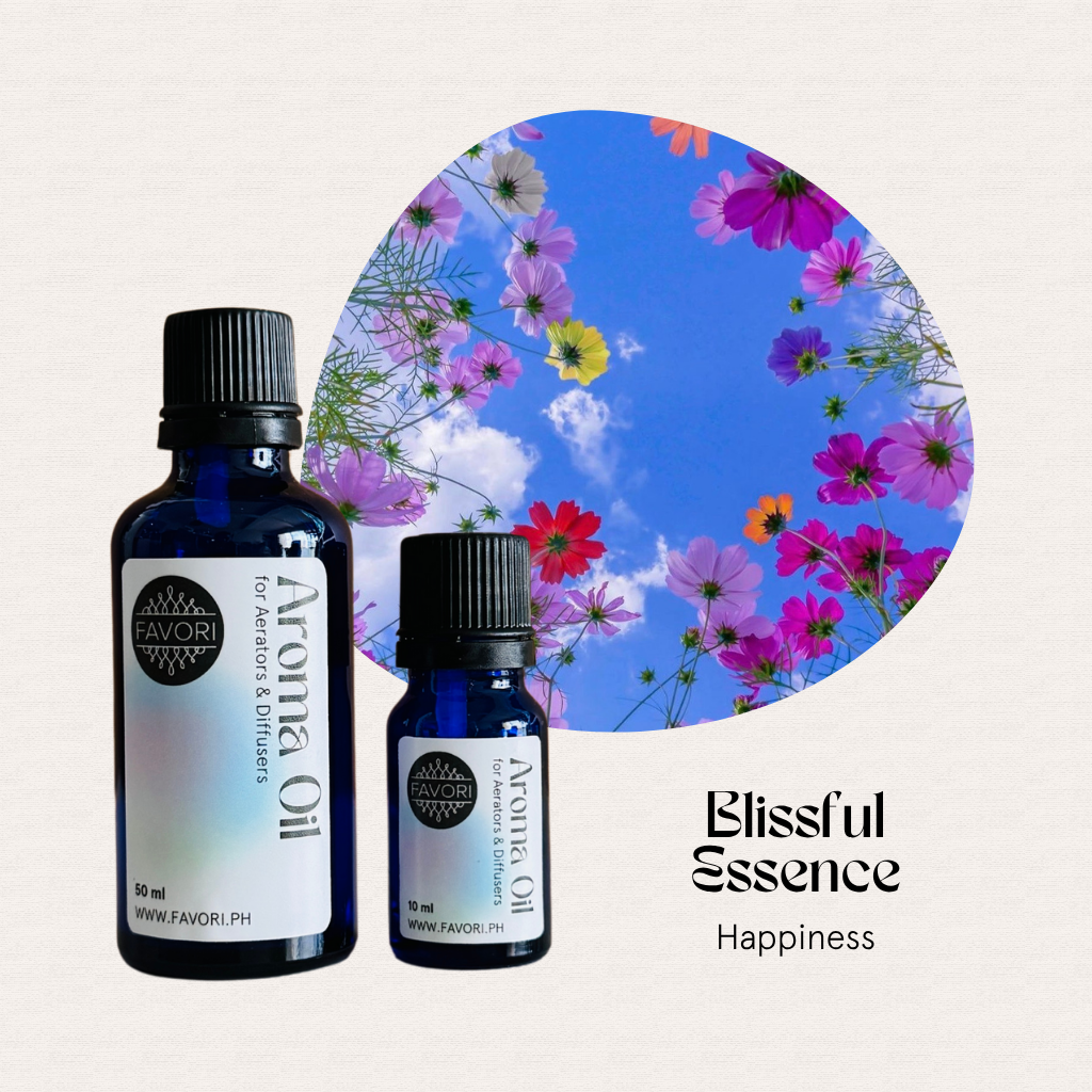Two blue bottles of FAVORI Scents AD Aroma Oils; text reads “Blissful Essence Happiness.”.