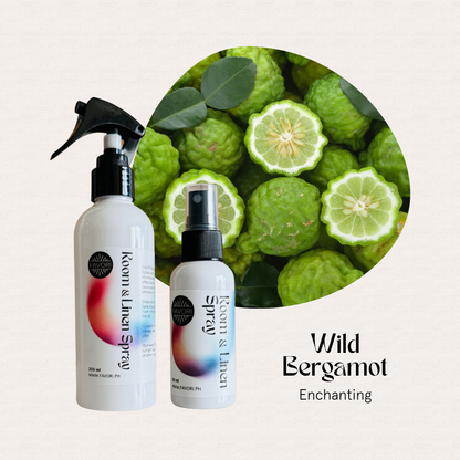 Two FAVORI Scents Regular Room & Linen Air Sprays beside sliced green bergamot—Wild Bergamot Enchanting.