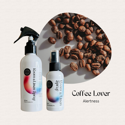 Two FAVORI Scents Regular Room & Linen Air Sprays, Coffee Lover Alertness, beside scattered beans.