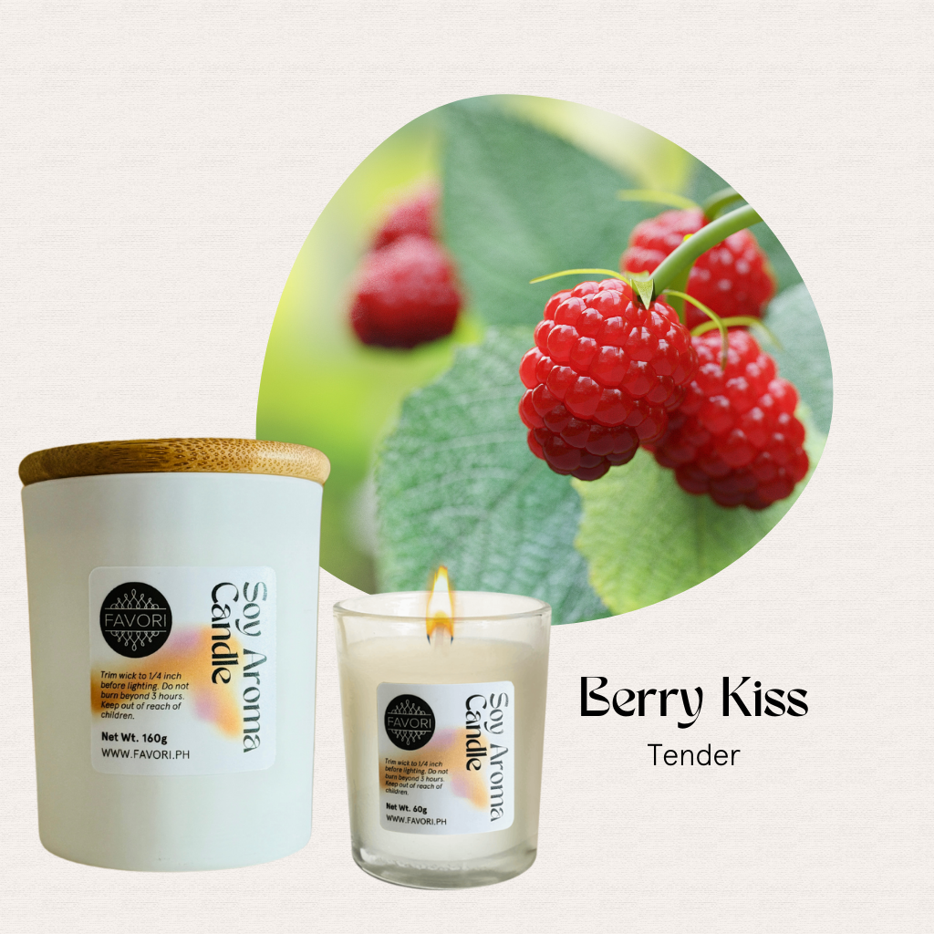 A lit FAVORI Scents All Occasion candle sits beside ripe raspberries on a leafy branch.