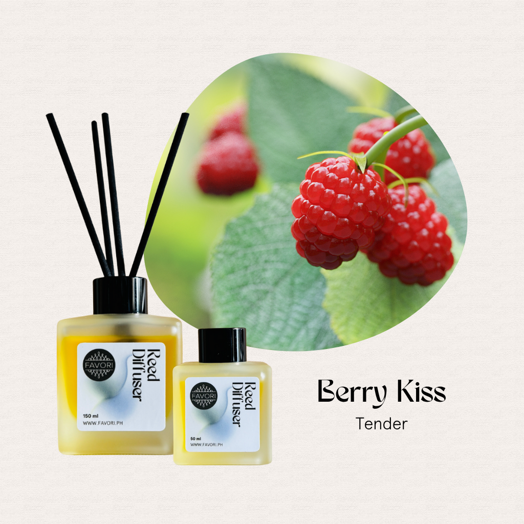 Two FAVORI Scents Berry Kiss RRDs with black sticks beside fresh raspberries on a leafy branch.