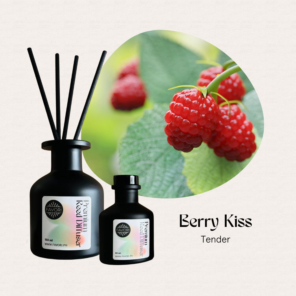 FAVORI Scents Berry Kiss Premium Reed Diffuser (PRD) is displayed next to fresh raspberries on green leaves.