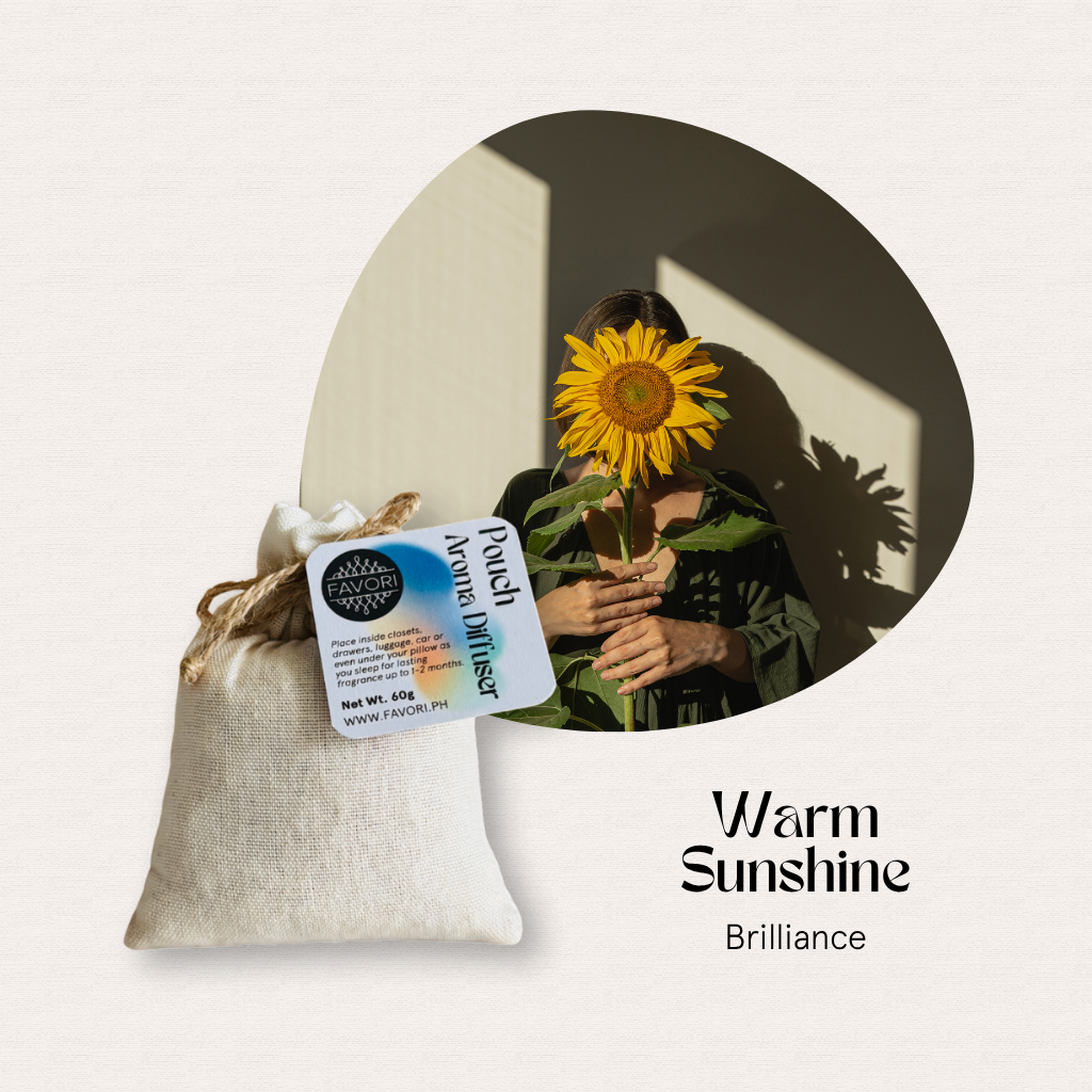 Someone hides behind a sunflower; a FAVORI Scents PAD Warm Sunshine aroma diffuser pouch sits in the corner.