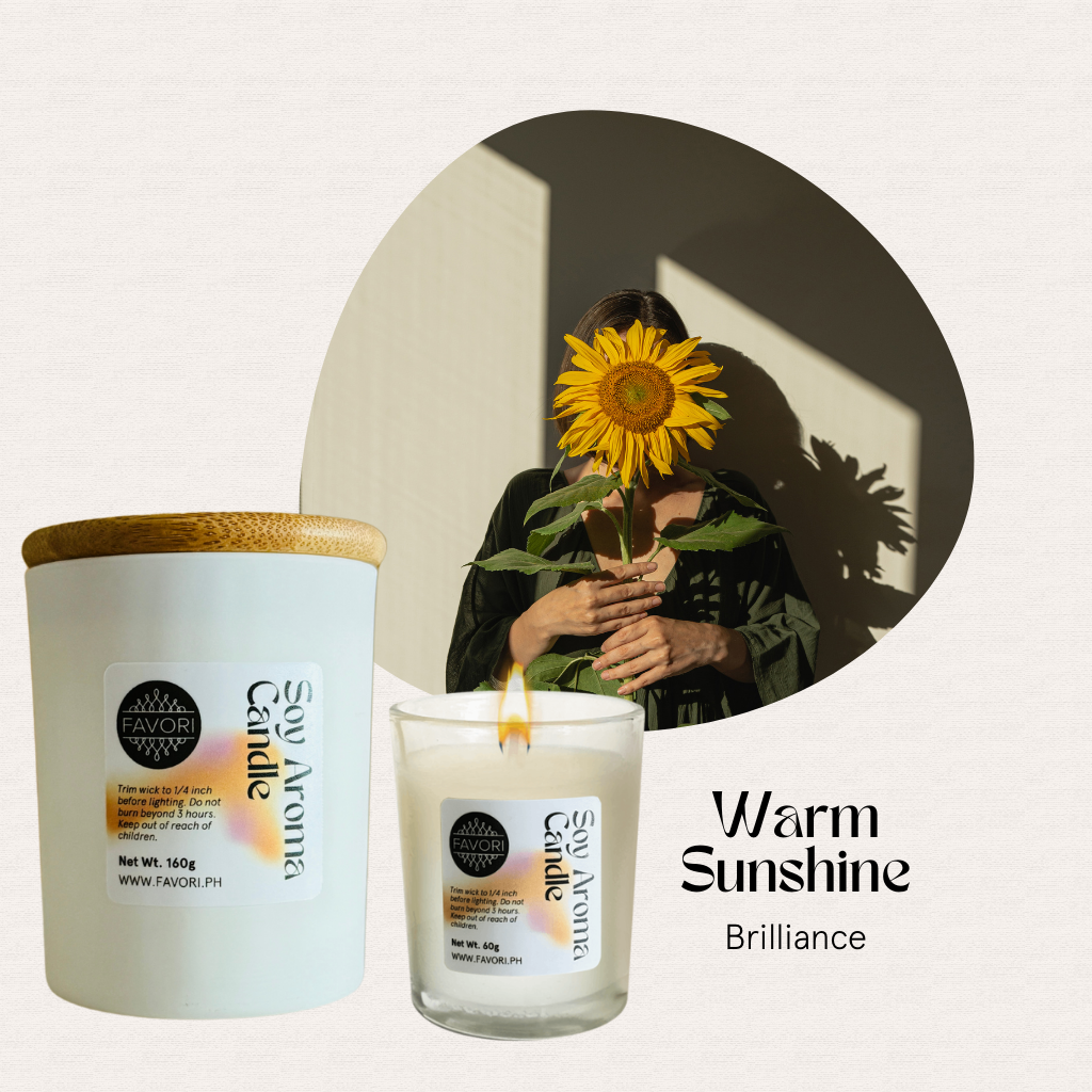 A woman holds a sunflower beside two FAVORI Scents All Occasion candles with wooden lids.