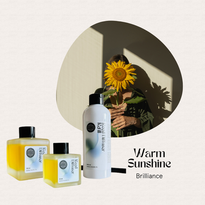 FAVORI Scents’ Warm Sunshine Trio Reed Diffuser (TRD) displayed, with a woman and sunflower in the background.