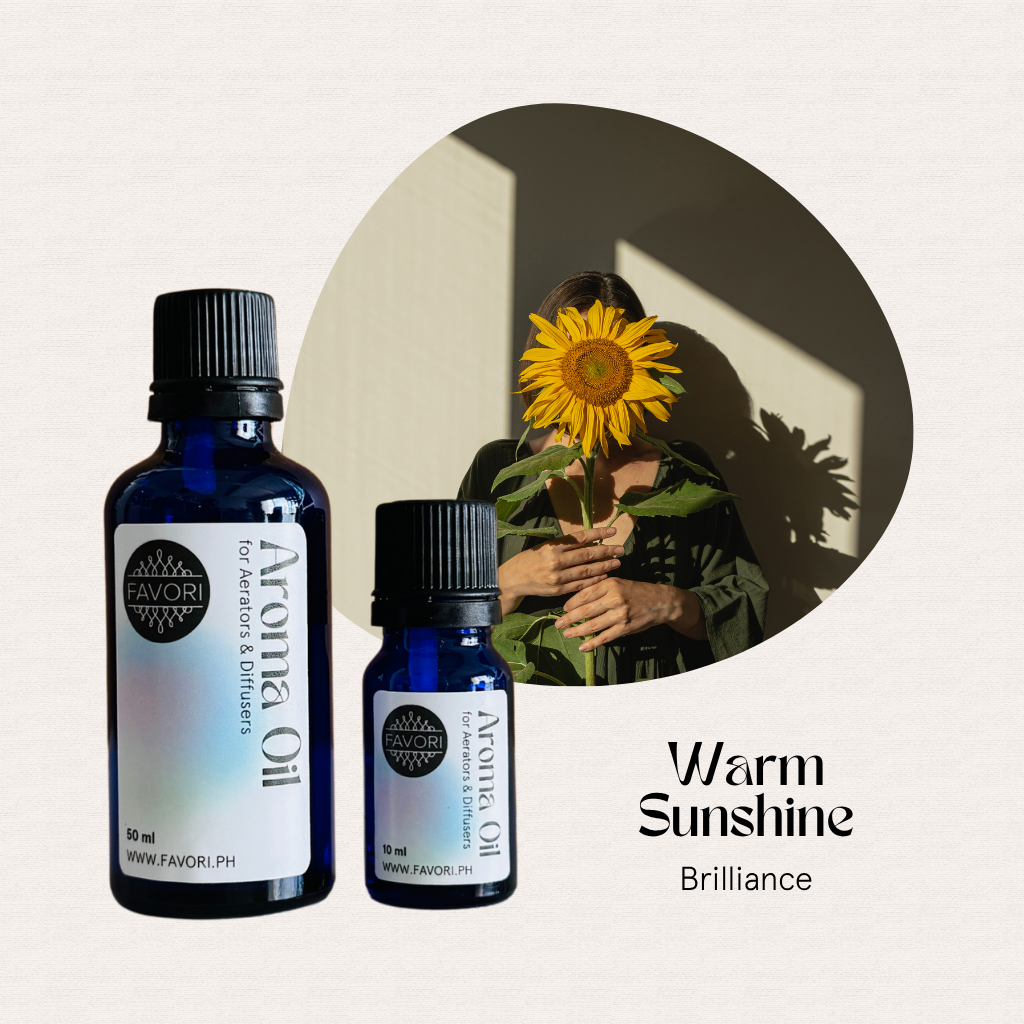 Two FAVORI Scents AD Aroma Oil bottles sit before a woman holding a sunflower in sunlight.