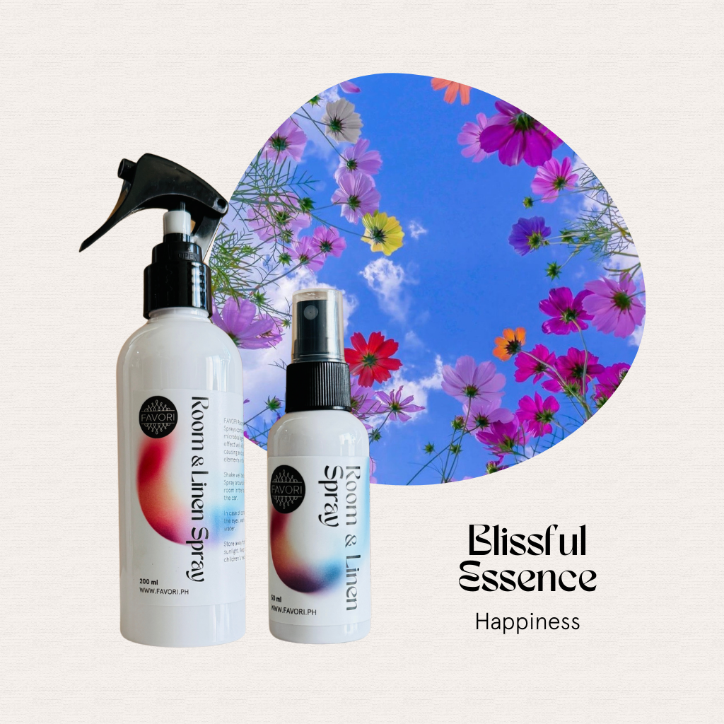 Two FAVORI Scents Room & Linen Air Sprays, flower-filled sky, Blissful Essence Happiness text on cream background.