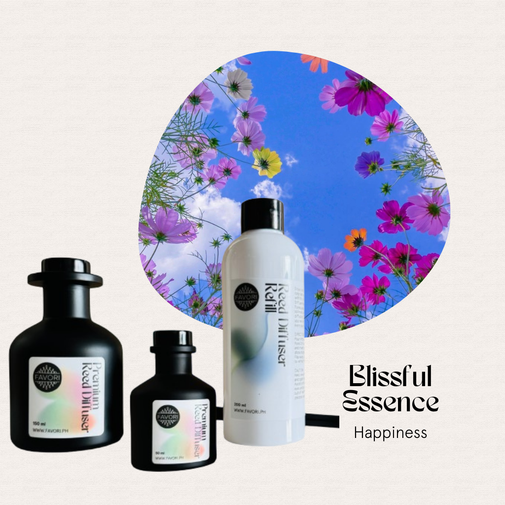 Three Blissful Essence Trio Reed Diffusers by FAVORI Scents, with flowers and a blue sky in the background.
