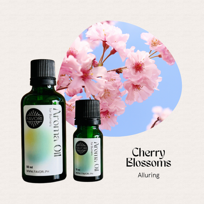Two FAVORI Scents Burner Aroma Oils beside pink cherry blossoms, labeled Cherry Blossoms Alluring.