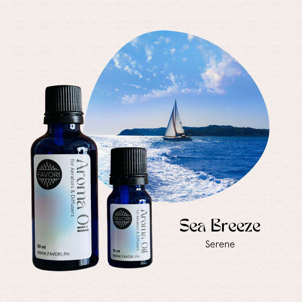 Two FAVORI Scents AD Aroma Oils by a sailboat, offering a long-lasting scent under blue ocean skies.