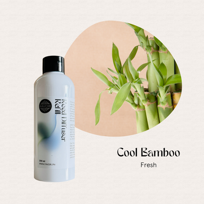 White FAVORI Scents Cool Bamboo Reed Diffuser Refill beside fresh bamboo, highlighting a crisp bamboo scent.