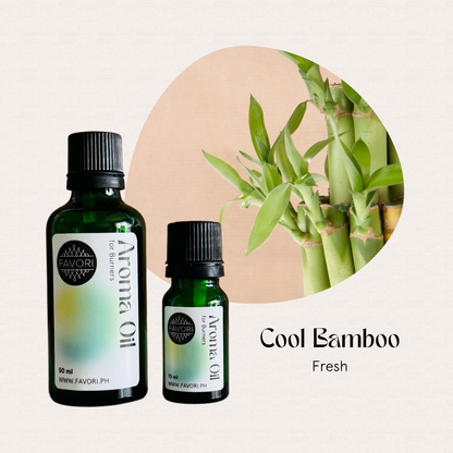 Two green FAVORI Scents BR Aroma Oils labeled Cool Bamboo Fresh beside bamboo stalks.