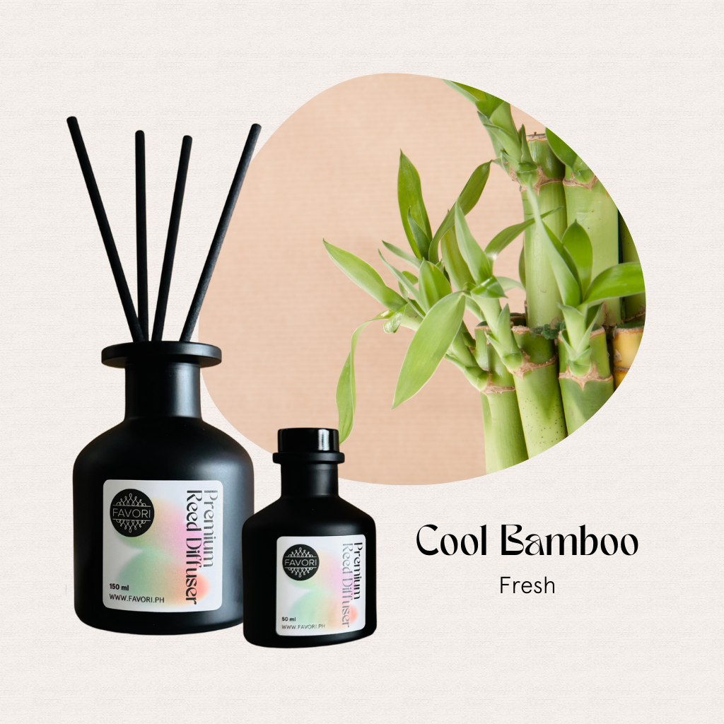 FAVORI Scents Cool Bamboo Premium Reed Diffuser beside bamboo stalks on a light textured background.