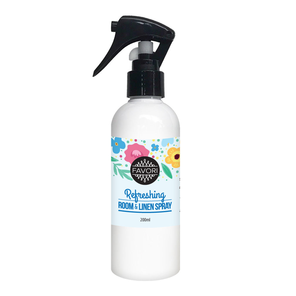 White spray bottle labeled "FAVORI Scents Refreshing Room & Linen Air Spray with Oil - 200ml" with floral graphics.