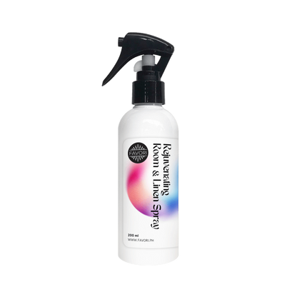 FAVORI Scents Rejuvenating Room & Linen Air Spray (AS) features a black nozzle and colorful gradient design.
