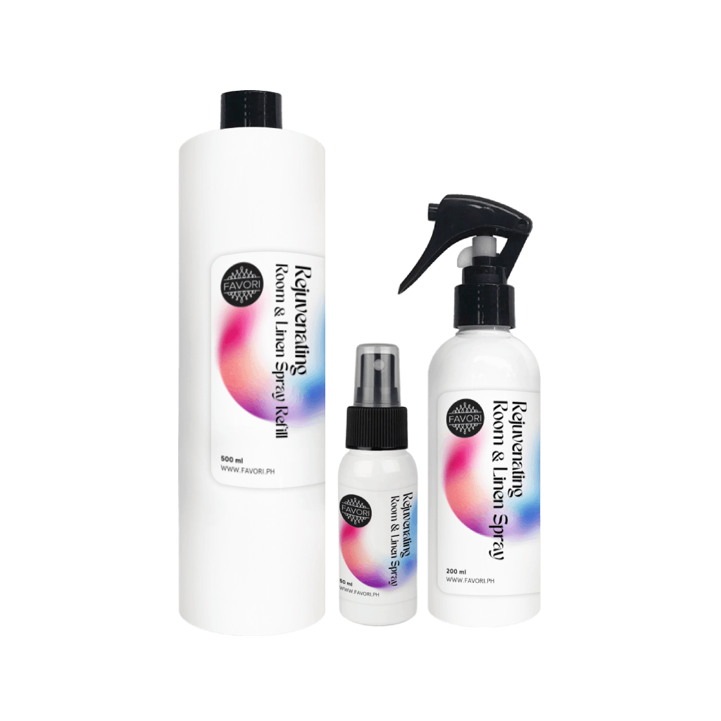 Three white bottles of FAVORI Scents Rejuvenating Room & Linen Air Spray with black caps and gradient labels.