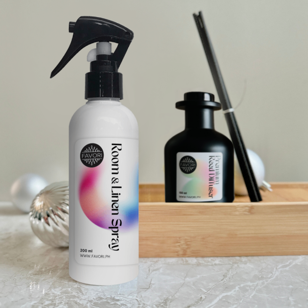 FAVORI Scents Air Spray (200ml) with spray nozzle and Premium Reed Diffuser (150ml) on table.