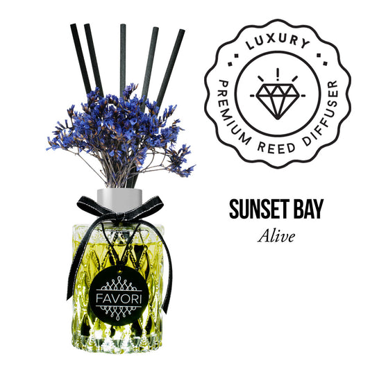 Aromatic oil reed diffuser with blue flowers and a label reading "Sunset Bay Premium Reed Diffuser - alive" by FAVORI Scents.