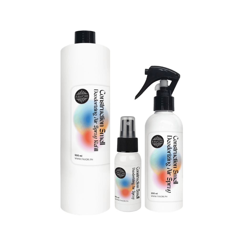 Three white FAVORI Scents Contruction Deodorizing Air Spray bottles in assorted sizes with vibrant labels.