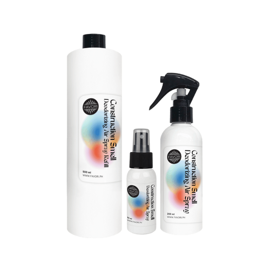Three white FAVORI Scents Contruction Deodorizing Air Spray bottles in assorted sizes with vibrant labels.