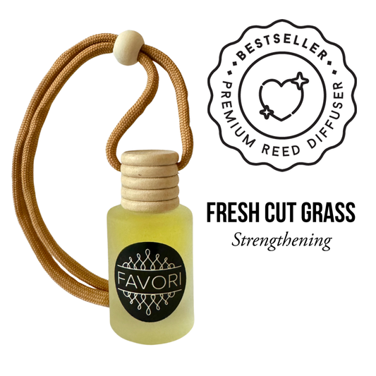 The image showcases a small, frosted bottle labeled "Favori" with a wooden cap and a brown braided cord handle. Text to the right states "BESTSELLER PREMIUM REED DIFFUSER." Below it reads "Fresh Cut Grass Hanging Aroma Diffuser (HAD) Strengthening." This compact diffuser ensures a lasting fragrance, perfect for aromatherapy.