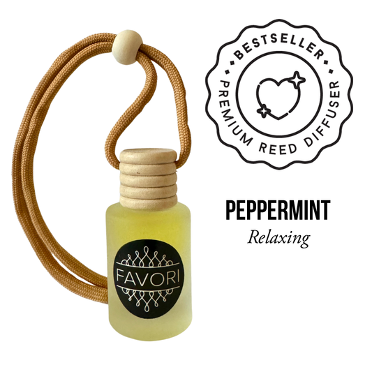 A small glass bottle labeled "FAVORI Scents" contains yellow liquid and has a wooden cap with a brown cord looped through it. Next to the bottle, text reads "Peppermint Hanging Aroma Diffuser (HAD) Relaxing." There's also a badge with hearts and stars and the words "BESTSELLER PREMIUM REED DIFFUSER," promising a lasting fragrance.