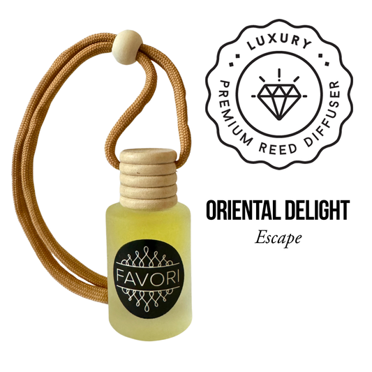 An image of an Oriental Delight Hanging Aroma Diffuser (HAD) by FAVORI Scents. The diffuser bottle, crafted from frosted glass with a black label displaying the brand name and logo, exudes elegance. It has a wooden cap and is attached to a brown cord with a white bead. To the right, text reads "LUXURY PREMIUM AROMA DIFFUSER ORIENTAL DELIGHT Escape".