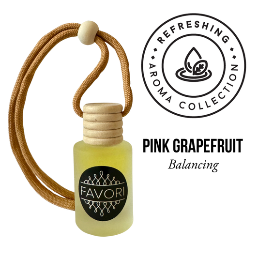 A small glass bottle containing yellow liquid with a wooden cap and an orange hanging cord. The bottle is labeled "FAVORI Scents." Accompanying text reads "PINK GRAPEFRUIT Hanging Aroma Diffuser (HAD) Balancing." At the top right, a circular logo with a leaf and water droplet design says "REFRESHING AROMA COLLECTION." This portable fragrance ensures a lasting scent wherever you go.