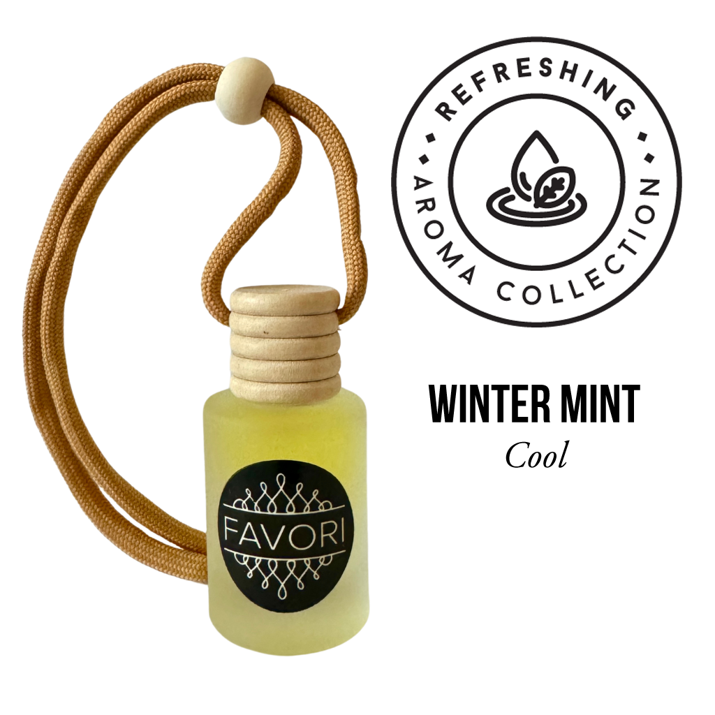 A small glass diffuser bottle of Winter Mint Hanging Aroma Diffuser (HAD) by FAVORI Scents hangs by a tan rope with a wooden bead and cap. The black and white logo stands out on the portable bottle. Above it, a circular logo reads "Refreshing Aroma Collection" with a leaf and water drop icon. Text below says "Winter Mint, Cool".