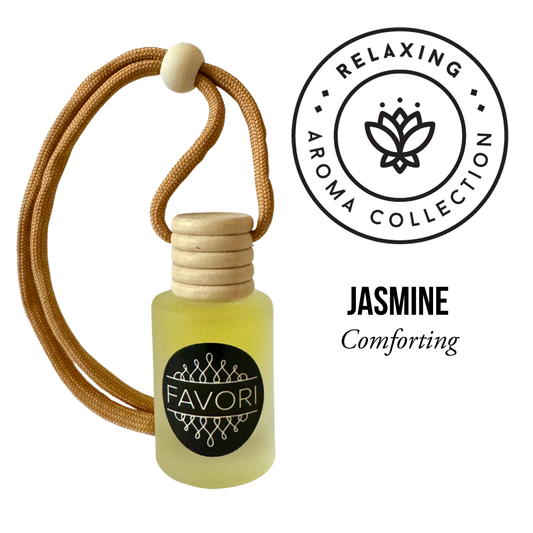 A small glass bottle of jasmine essential oil with a wooden cap and a looped beige cord. The bottle is labeled "FAVORI Scents." Above, a circular emblem reads "Relaxing Aroma Collection" and features a lotus flower design. This portable fragrance offers a lasting aroma of "Jasmine Comforting." It is the perfect example of the Jasmine Hanging Aroma Diffuser (HAD).