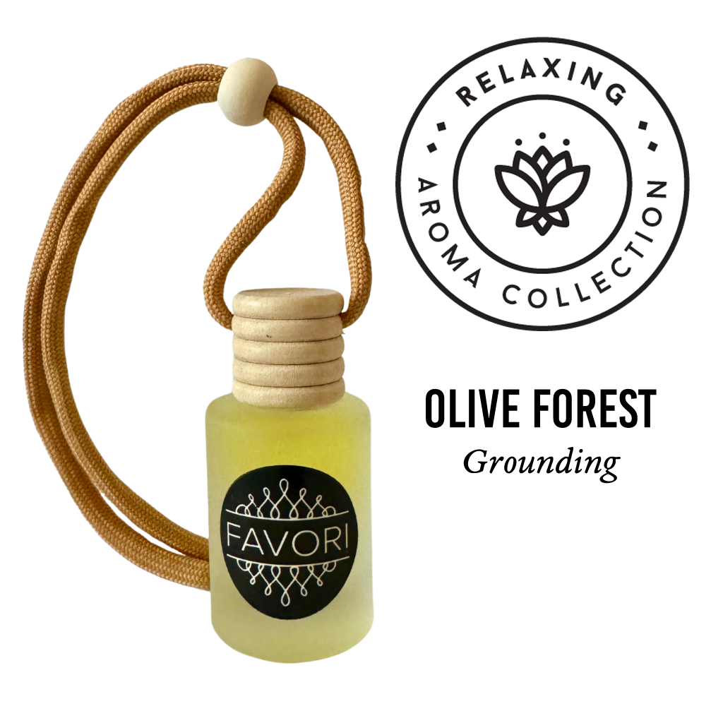 A small bottle of FAVORI Scents essential oil labeled "Olive Forest Hanging Aroma Diffuser (HAD)" with the word "Grounding" underneath. The bottle, doubling as a portable diffuser, features a natural wooden cap and is attached to a brown cord with a wooden bead. Beside it is a round logo with "Relaxing Aroma Collection" surrounding a lotus design.