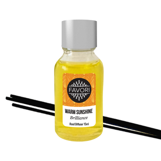 A bottle of FAVORI Scents Warm Sunshine Mini Reed Diffuser (MRD) with black fiber reed sticks on a white background at Marriott Hotel.