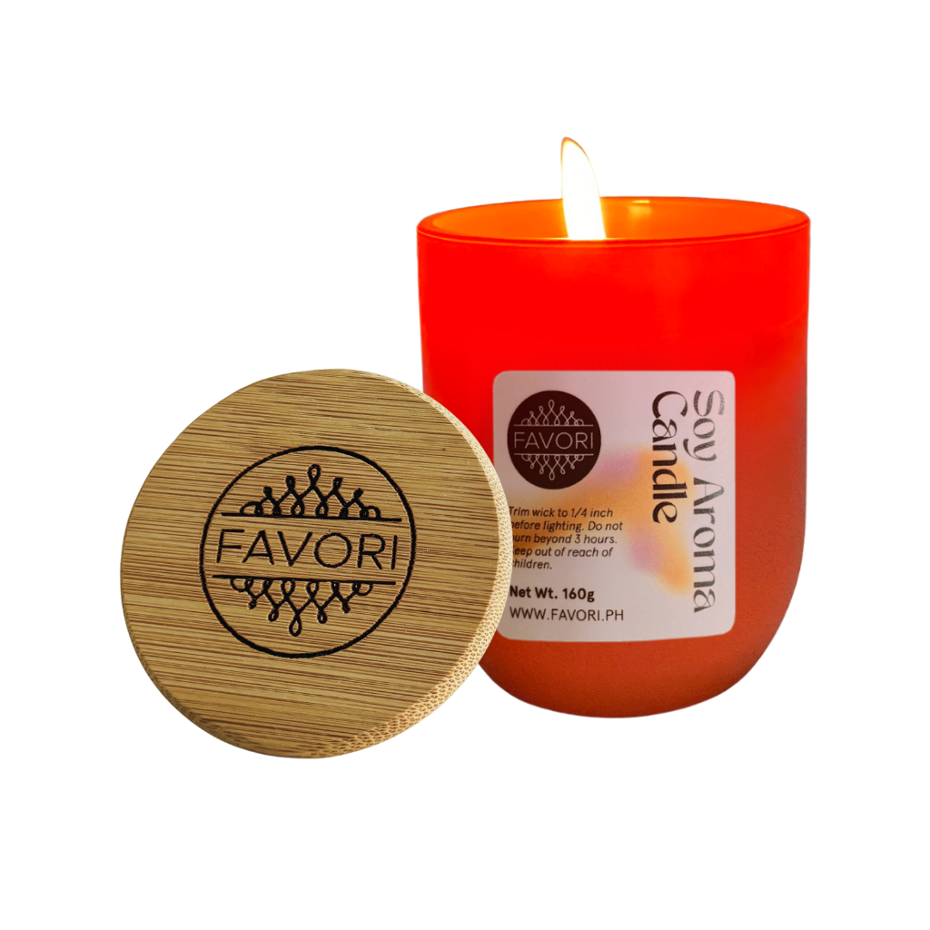 A lit Yuletide Occasion soy candle by FAVORI Scents with a wooden lid sits on a white background.